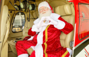 Depois de chegada em helicóptero, Papai Noel tira fotos com consumidores do Shopping União